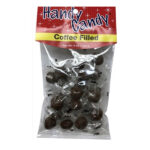 A clear plastic bag labeled Handy Candy COFFEE FILLED holds several individually wrapped brown candies. The red and yellow packaging features white text and a festive, sparkling design.