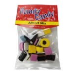 A clear plastic bag labeled Handy Candy ALLSORT MIX LICORICE contains assorted colorful licorice candies in different shapes and colors, such as yellow, pink, white, and black.