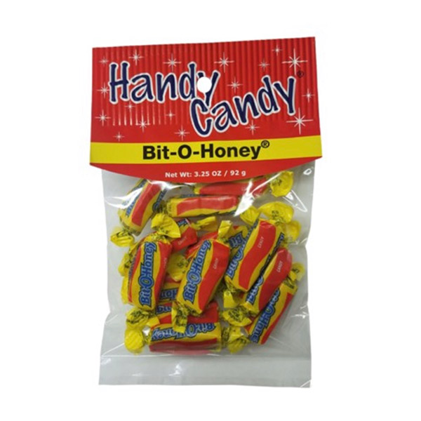 A clear Handy Candy BIT-O-HONEY bag holds individually wrapped Bit-O-Honey candies in yellow, red, and blue wrappers, with a net weight of 3.25 oz (92 g).